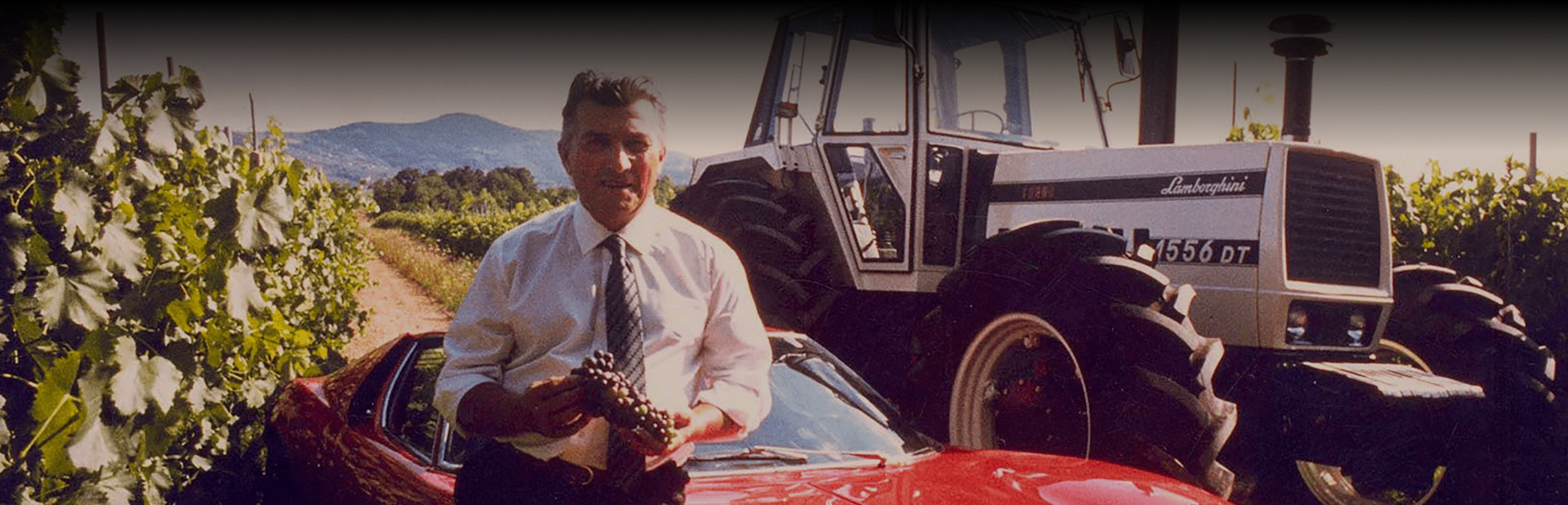 Ferruccio Lamborghini holding a a bunch of grapes
