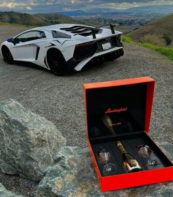 Lamborghini Oro Vino Spumante with gift set against scenic backdrop
